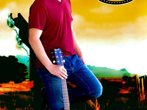 A man in a red shirt and blue jeans poses with an acoustic guitar against a rural backdrop with a windmill and sunset. An emblem above him reads "Todd Barrow.